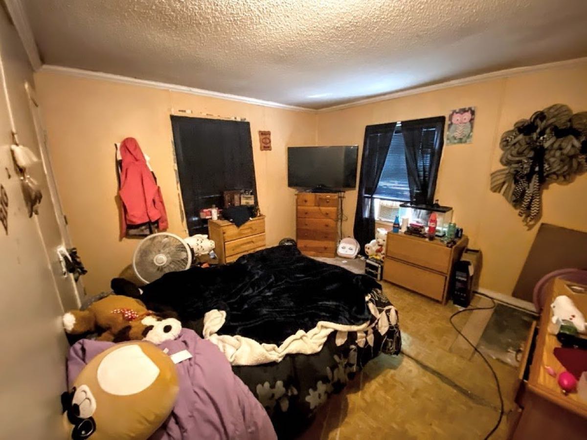 Bedroom full of belongings in the Kannapolis house on Michigan St purchased as-is