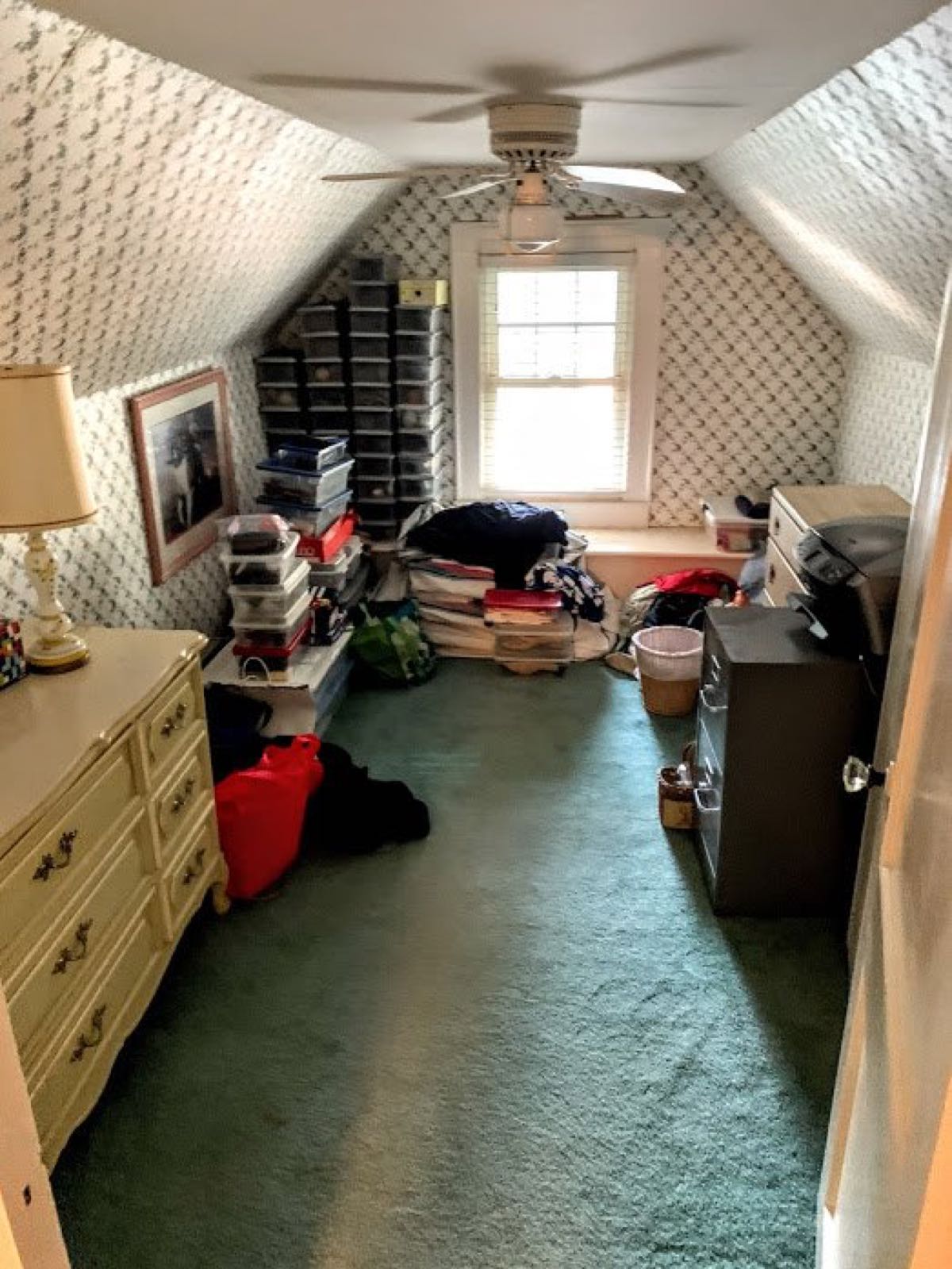 Room piled with belongings in a Mooresville house purchased as-is